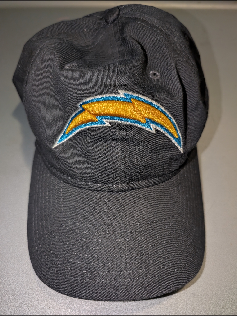 New Era Black Hat with Gold & Blue Lightning Logo
